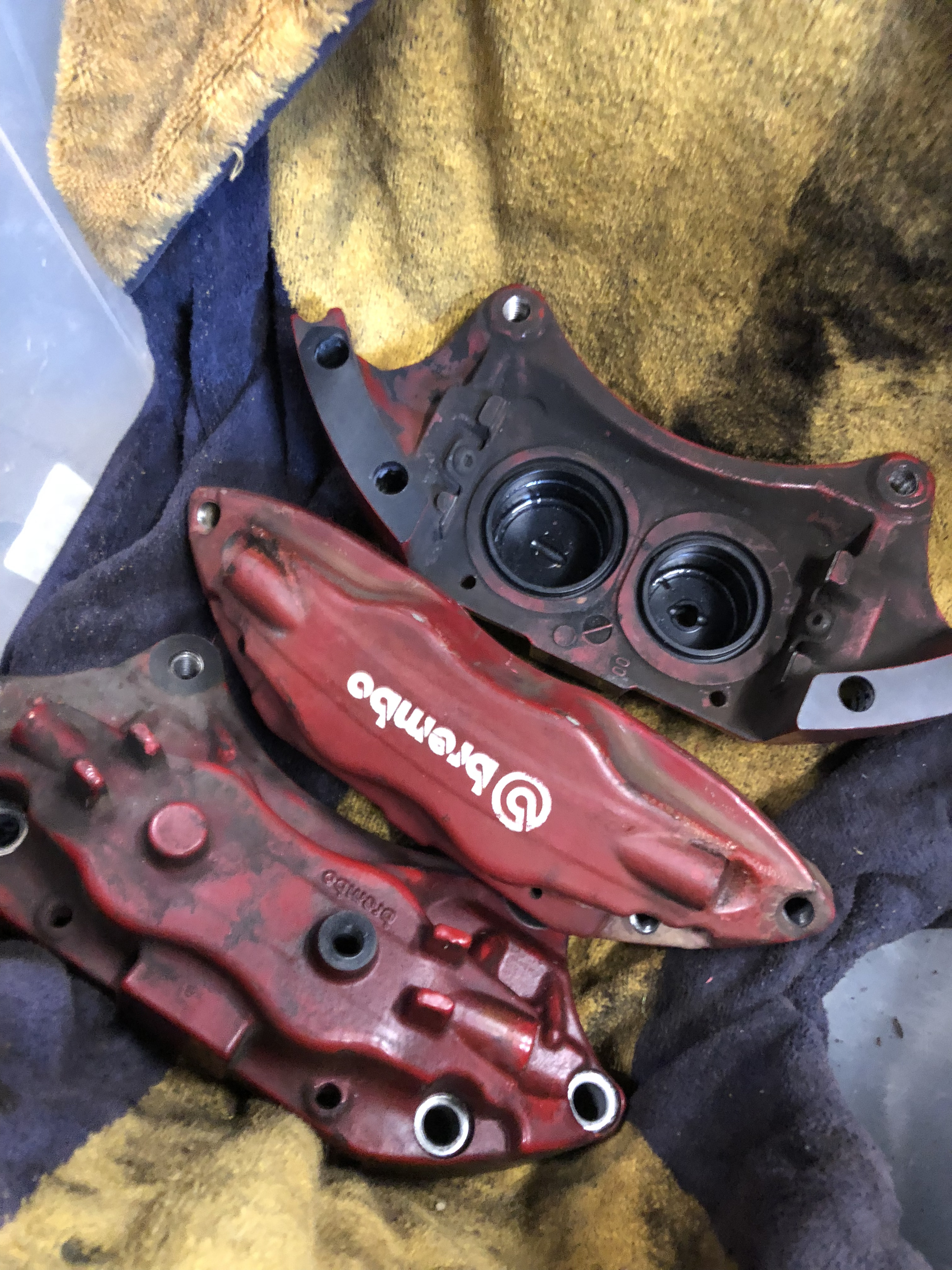 Brake calipers before blasting — used and paint-worn